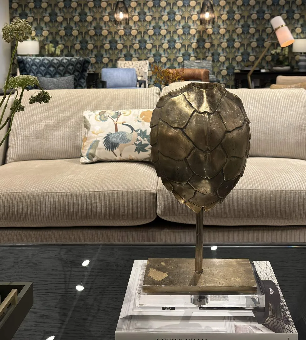 A living room with a dark brown leather sofa, wooden cabinet, and a wooden coffee table with decorative items