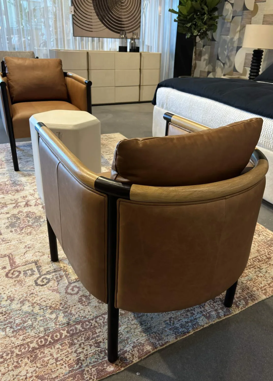 Cream chenille throw folded neatly on the seat of a charcoal velvet armchair, showing how a lighter texture reads against dark upholstery